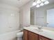 Bathroom features a tub, vanity and a large mirror at 14137 Wake Robin Dr, Brooksville, FL 34604