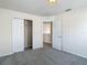 View of bedroom with carpeting, doors, neutral paint, and closet with sliding doors at 14137 Wake Robin Dr, Brooksville, FL 34604