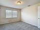 Bright bedroom features plush carpet, window and neutral paint at 14137 Wake Robin Dr, Brooksville, FL 34604