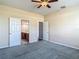 Bedroom with ceiling fan and carpet flooring has an ensuite bathroom with dual sinks and a separate toilet at 14137 Wake Robin Dr, Brooksville, FL 34604