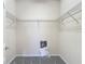 An empty walk-in closet with wire shelving and gray carpeting provides ample storage space at 14137 Wake Robin Dr, Brooksville, FL 34604