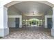 Covered entranceway with paver flooring and security doors leading to the pool area at 14137 Wake Robin Dr, Brooksville, FL 34604