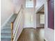 Inviting foyer features a staircase, soaring ceilings, and wood-look tile flooring at 14137 Wake Robin Dr, Brooksville, FL 34604