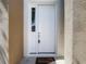 Close-up of a white front door with a side window panel and a 'Welcome' mat at 14137 Wake Robin Dr, Brooksville, FL 34604