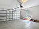 An open garage shows the door and mechanicals along with a window and lawn equipment at 14137 Wake Robin Dr, Brooksville, FL 34604