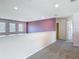 Upstairs hallway with carpet, natural light, and a purple accent wall at 14137 Wake Robin Dr, Brooksville, FL 34604