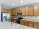 Well-equipped kitchen with stainless steel appliances, tiled backsplash, and ample counter space at 14137 Wake Robin Dr, Brooksville, FL 34604