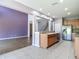 Open concept kitchen with stainless steel appliances and a view of the living area and staircase at 14137 Wake Robin Dr, Brooksville, FL 34604