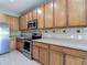 Kitchen featuring stainless steel appliances, ample cabinet space, and tiled backsplash at 14137 Wake Robin Dr, Brooksville, FL 34604