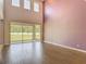 Bright living room with tile floors, high ceilings, slider doors to backyard, and ample natural light at 14137 Wake Robin Dr, Brooksville, FL 34604