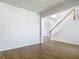 Spacious living room with hard wood flooring, white walls, and staircase at 14137 Wake Robin Dr, Brooksville, FL 34604