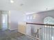 Carpeted loft featuring arched windows and views of the home's entryway at 14137 Wake Robin Dr, Brooksville, FL 34604