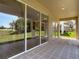 The covered patio boasts tile floors and large sliding glass doors looking out to a beautiful backyard at 14137 Wake Robin Dr, Brooksville, FL 34604