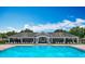 Community pool with large covered veranda, ample seating and a blue sky overhead at 14137 Wake Robin Dr, Brooksville, FL 34604
