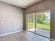 Bright room with tile flooring and sliding glass doors leading to the backyard at 14137 Wake Robin Dr, Brooksville, FL 34604