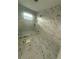 Bathroom with glass shower featuring marble tiling and contemporary fixtures under construction at 14273 Nugent Circle, Spring Hill, FL 34609