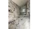 Contemporary bathroom featuring marble-style tile, frameless glass shower, and modern fixtures under construction at 14273 Nugent Circle, Spring Hill, FL 34609