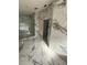Modern bathroom featuring marble-style tiling, frameless glass shower, and contemporary fixtures under construction at 14273 Nugent Circle, Spring Hill, FL 34609