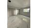 Unfurnished bedroom with marble-style tile flooring and natural light, under construction at 14273 Nugent Circle, Spring Hill, FL 34609