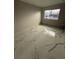 Cozy bedroom featuring marble floors and a large window, providing natural light and a modern feel at 14273 Nugent Circle, Spring Hill, FL 34609