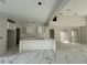 A bright kitchen area featuring white cabinets, marble countertops and floors and a large kitchen island at 14273 Nugent Circle, Spring Hill, FL 34609