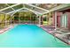 Relaxing screened-in pool area with a hot tub, offering the perfect space for outdoor fun at 14273 Nugent Circle, Spring Hill, FL 34609