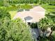 High angle looking down on the home and showcasing the front entryway, driveway and the surrounding landscaping at 15101 Kestrelglen Way, Lithia, FL 33547
