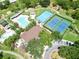 Aerial view of community amenities including pool, tennis courts, basketball court, clubhouse, and playground at 15101 Kestrelglen Way, Lithia, FL 33547