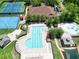 Aerial view of pool and aquatics center featuring olympic-size pool, toddler pool, playground, and tennis courts at 15101 Kestrelglen Way, Lithia, FL 33547