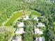 Picturesque aerial view of the property with waterfront and neighborhood showing lush landscaping and homes at 15101 Kestrelglen Way, Lithia, FL 33547