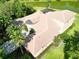 Birds eye aerial view of the property, showcasing a tiled roof, screened lanai and well-manicured surrounding landscape at 15101 Kestrelglen Way, Lithia, FL 33547