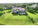 Wide aerial shot capturing the expansive backyard, sparkling pool, and screened in lanai of the house at 15101 Kestrelglen Way, Lithia, FL 33547