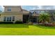 Backyard of the home with a screened-in pool area and lush green grass at 15101 Kestrelglen Way, Lithia, FL 33547