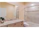 Well-lit bathroom with a granite-topped vanity, a large mirror, and a shower-tub combination at 15101 Kestrelglen Way, Lithia, FL 33547