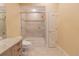 Bright bathroom featuring a shower-tub combination with a tiled surround at 15101 Kestrelglen Way, Lithia, FL 33547