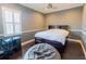 Comfortable bedroom with gray walls, dark wood floors, and a bed with built-in storage at 15101 Kestrelglen Way, Lithia, FL 33547
