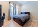 Cozy bedroom features hardwood floors, shutters, and a bedframe with built in drawers and shelves at 15101 Kestrelglen Way, Lithia, FL 33547
