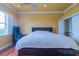 Bedroom with yellow walls, ceiling fan, and a bed that features built-in storage at 15101 Kestrelglen Way, Lithia, FL 33547