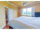 Cozy bedroom with yellow walls, ceiling fan and natural light from window at 15101 Kestrelglen Way, Lithia, FL 33547