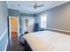Bright bedroom with a ceiling fan, white trim, and a window letting in natural light at 15101 Kestrelglen Way, Lithia, FL 33547