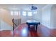 Upstairs bonus room features a pool table, hardwood floors, and bay windows with shutters at 15101 Kestrelglen Way, Lithia, FL 33547