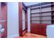 Custom closet features hardwood flooring, multiple shelves, hanging rods, and drawer space at 15101 Kestrelglen Way, Lithia, FL 33547