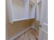 Walk-in closet with hardwood floors, white shelves, and a hanging rod at 15101 Kestrelglen Way, Lithia, FL 33547