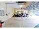 Spacious three car garage with golf cart, epoxy floor, and bright lighting at 15101 Kestrelglen Way, Lithia, FL 33547