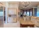 Spacious kitchen featuring granite countertops, stainless steel appliances, and elegant chandelier lighting at 15101 Kestrelglen Way, Lithia, FL 33547