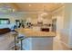 Open kitchen featuring granite countertops, a center island, and modern stainless steel appliances at 15101 Kestrelglen Way, Lithia, FL 33547