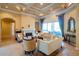 Comfortable living room with fireplace, window seat, coffered ceiling, and outdoor access at 15101 Kestrelglen Way, Lithia, FL 33547