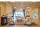 Elegant living room with coffered ceilings, fireplace, and sliding glass doors to the lanai at 15101 Kestrelglen Way, Lithia, FL 33547