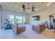 Bright living room with tile floors and comfortable seating. Includes exercise equipment for a home gym at 15101 Kestrelglen Way, Lithia, FL 33547
