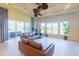 Large living room with natural light, comfortable seating, and access to the backyard and outdoor living area at 15101 Kestrelglen Way, Lithia, FL 33547